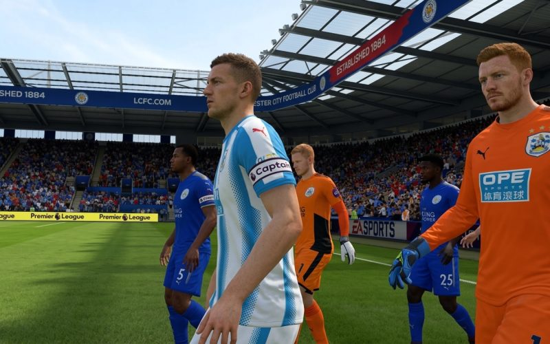 FIFA 18 Switch NSP Football players in blue and orange kits walking onto pitch at packed stadium